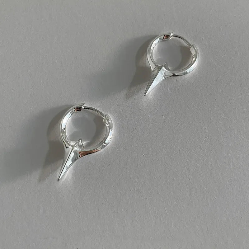 A pair of platinum-coloured geometric star-shaped clip-on earrings for women, made from electroplated copper.