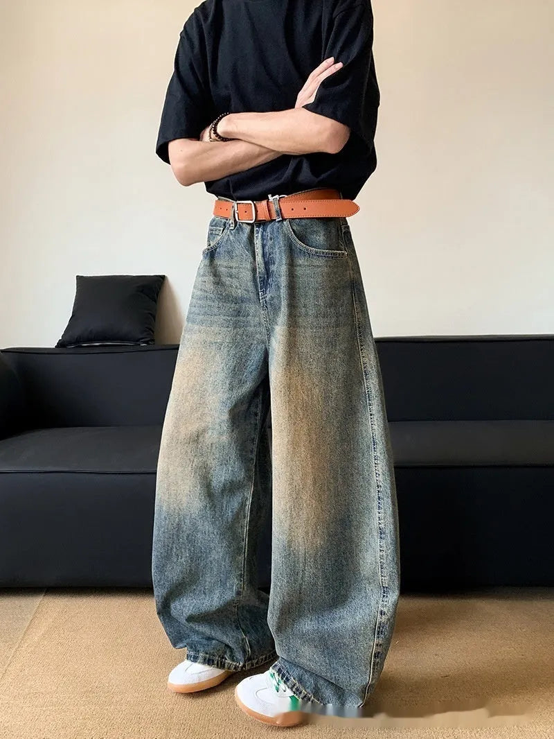 Retro blue distressed machete denim jeans for men with a wide-leg slim cut.