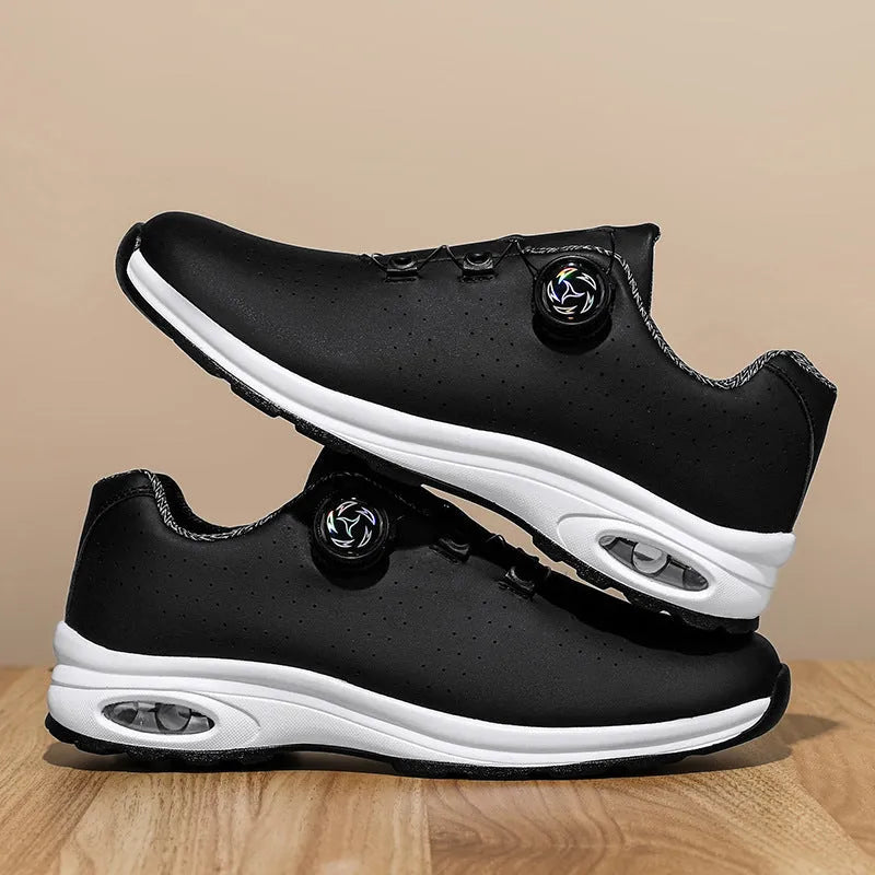 Black and white low top mesh casual shoes with cross shoulder straps and lace-up front.
