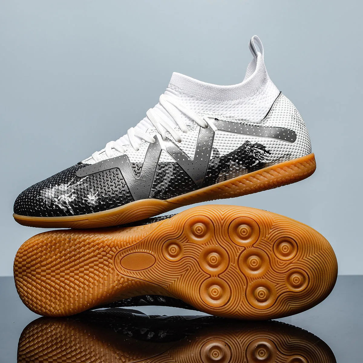 Adult low-top football boots in Black and Yellow colour with mesh lining and rubber sole.