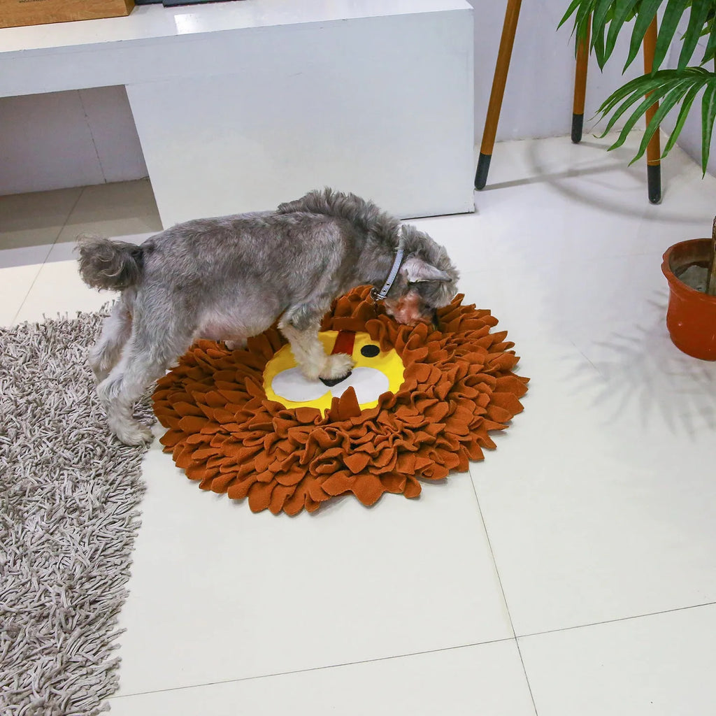 Brown lion-shaped sniffing pad pet toy for dogs and cats on a floor.