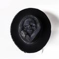 Handmade wool felt skull hat with a pointed conical crown for Halloween.
