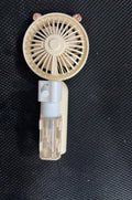 Compact plastic USB-powered nozzle fan in apricot, blue, green, orange or pink colour on a desk.