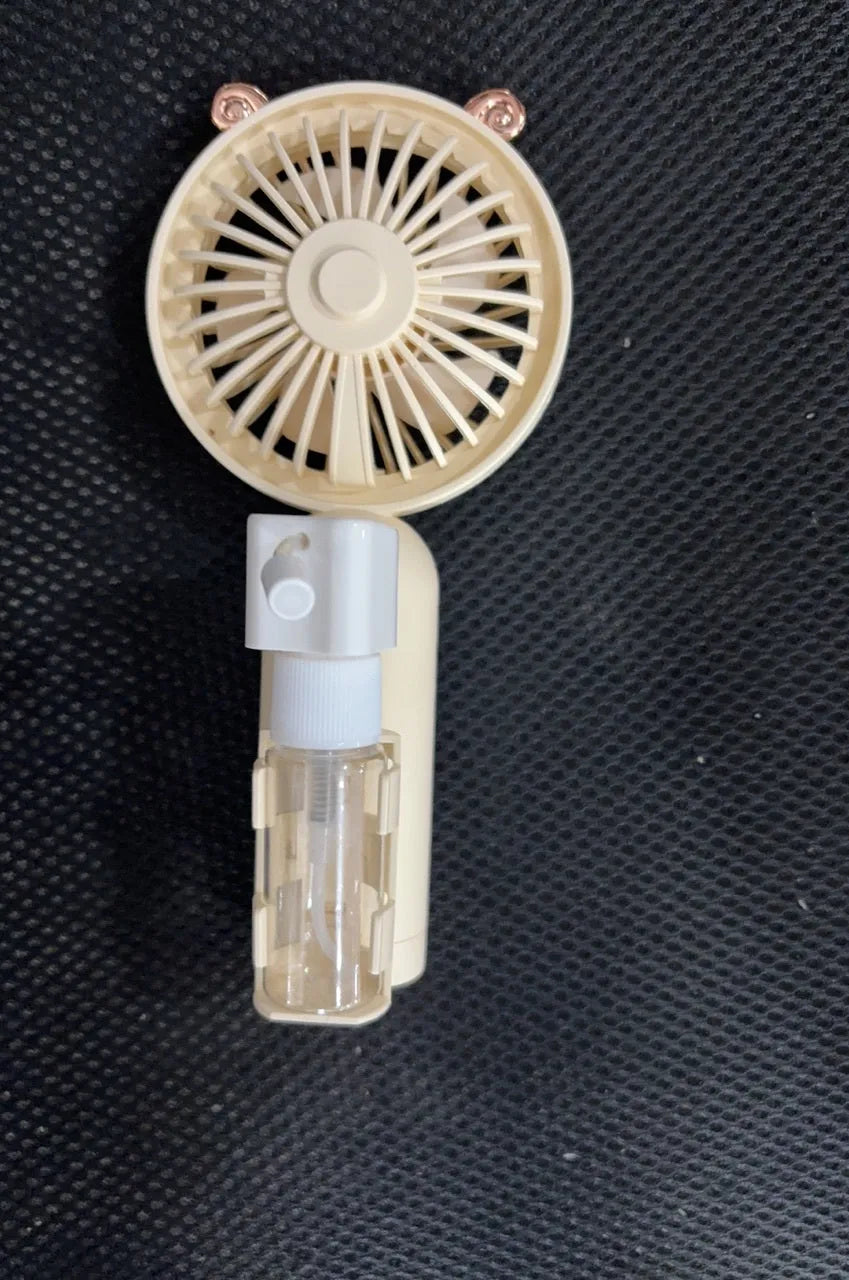 Compact plastic USB-powered nozzle fan in apricot, blue, green, orange or pink colour on a desk.