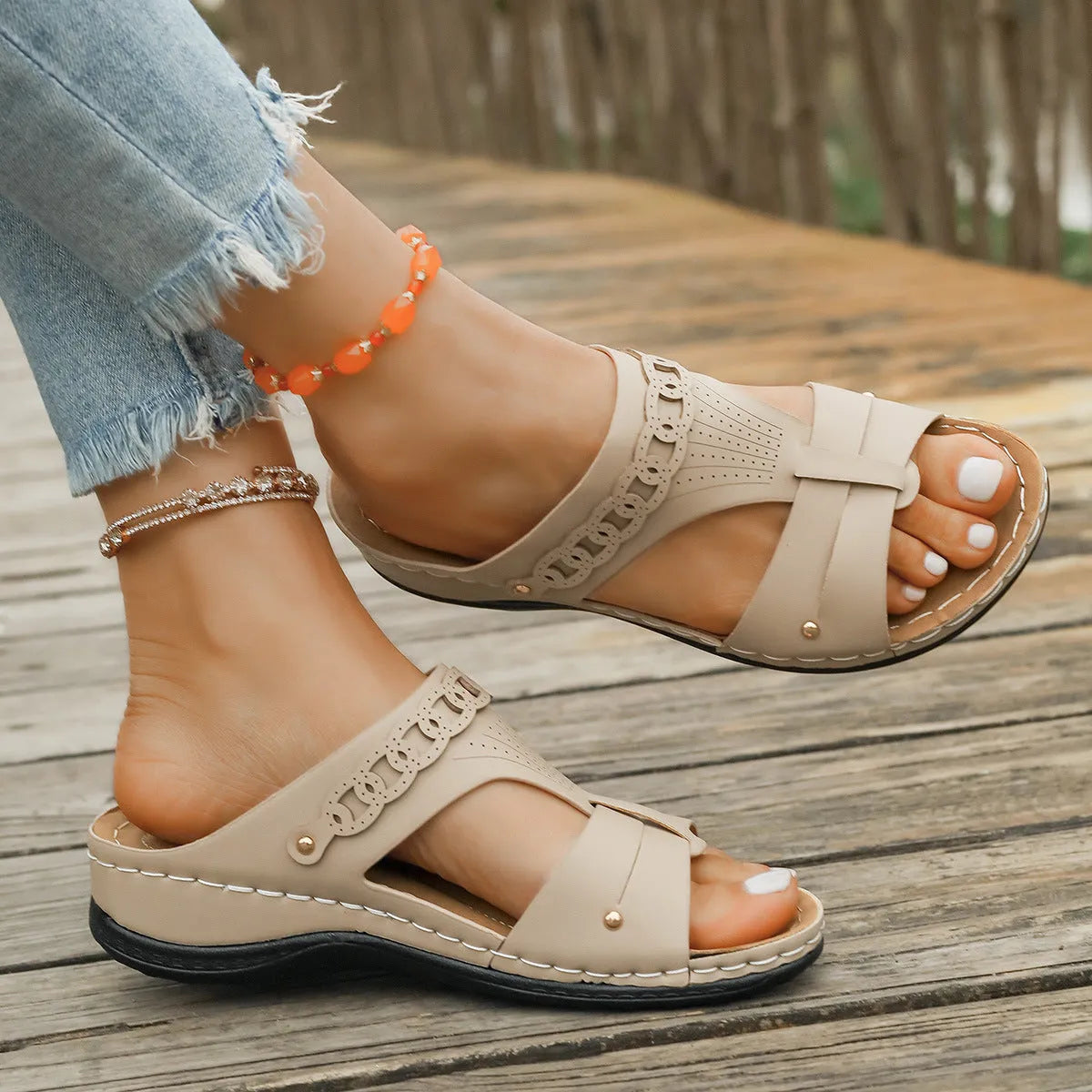 Blue casual slippers with a fish mouth toe holder and slope heel on a wooden floor.