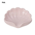 White and pink shell-shaped plastic soap dish for bathroom counter organisation.