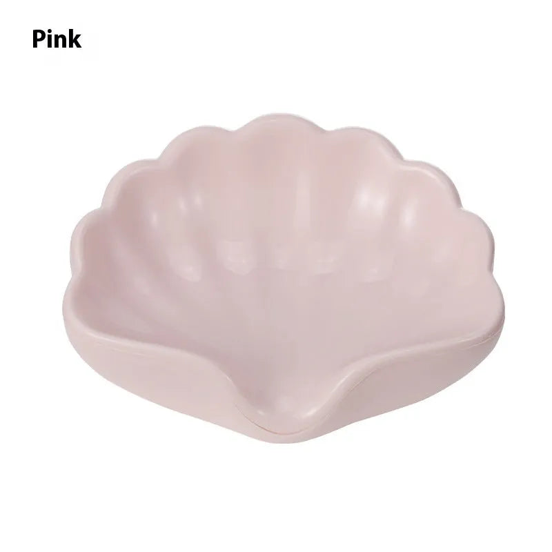 White and pink shell-shaped plastic soap dish for bathroom counter organisation.
