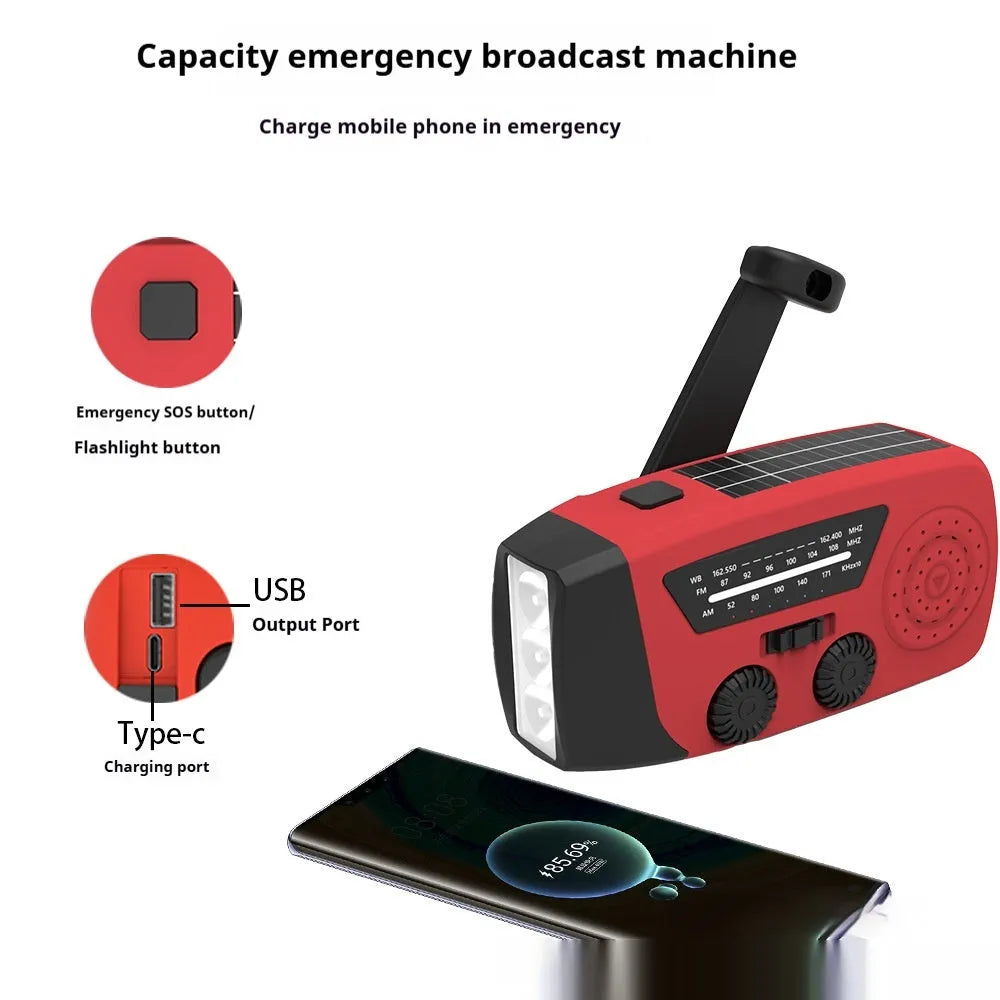 Red rechargeable emergency hand radio with torch, built-in speaker, USB port, and wrist strap.