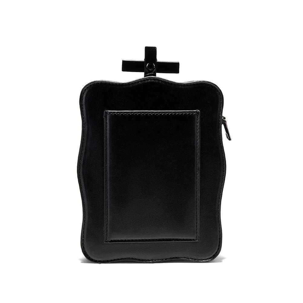 Black gothic crossbody bag with embossed skull design, chain strap and square shape