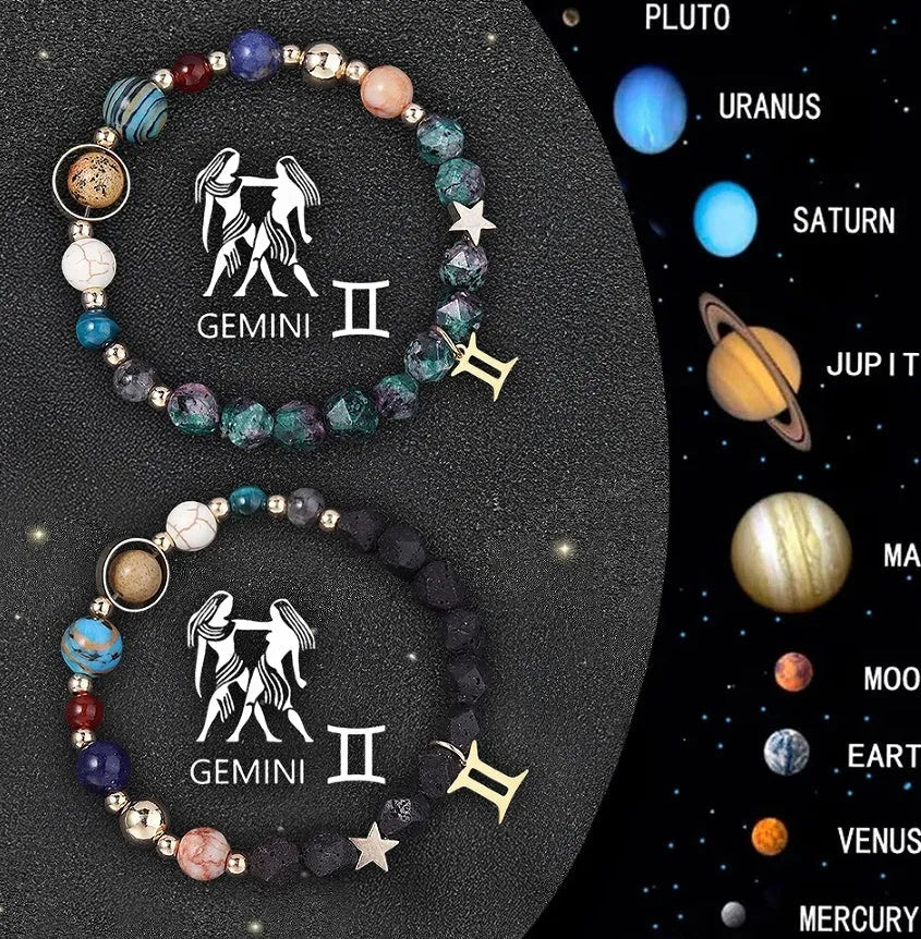 Two natural stone beaded bracelets with zodiac sign charms on a wooden surface.
