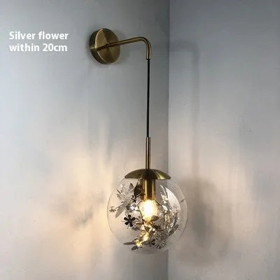 Modern glass wall lamp with minimalist design shown in bedroom setting