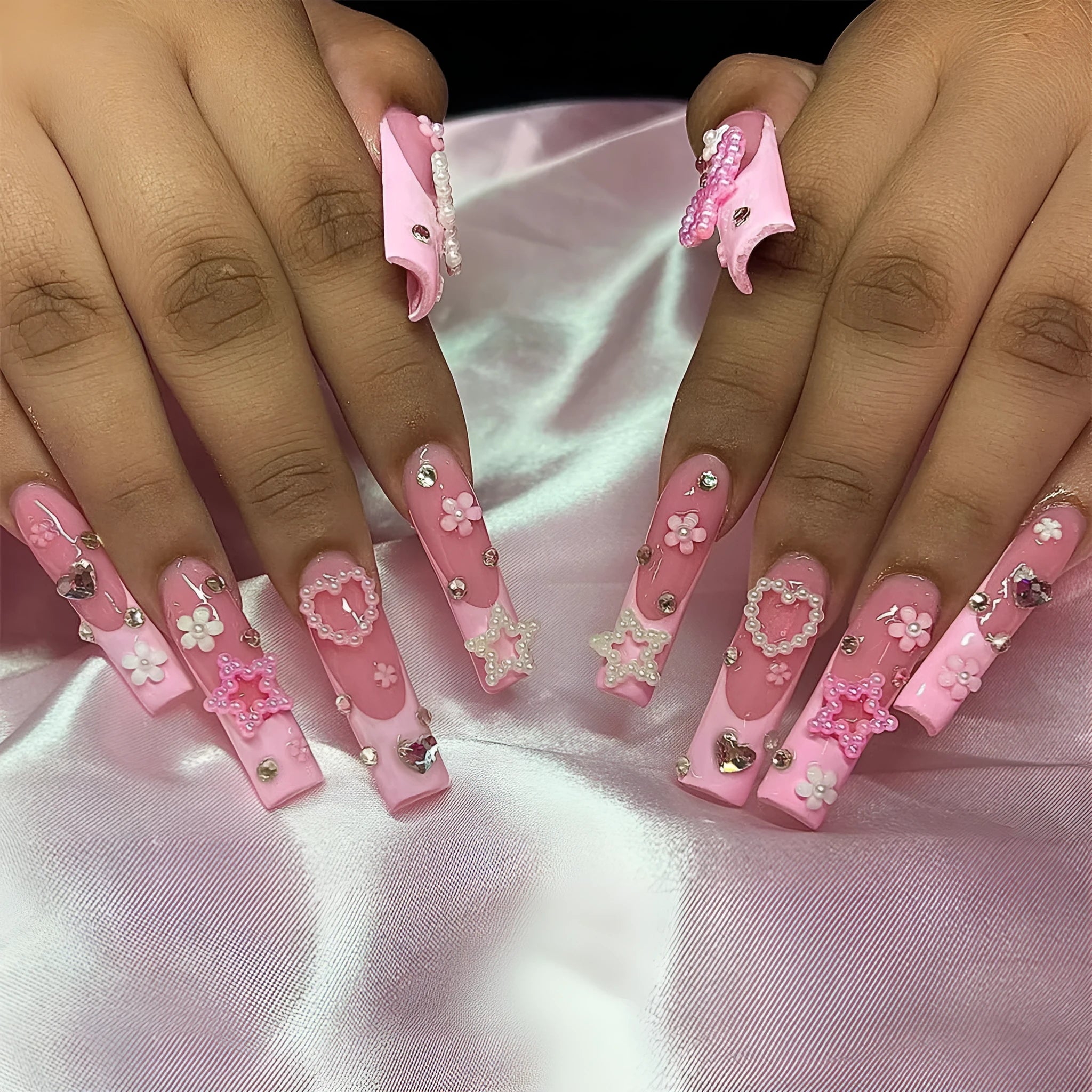 Close-up of a love pattern bow nail decoration in colour XB-70-48 on a nail.