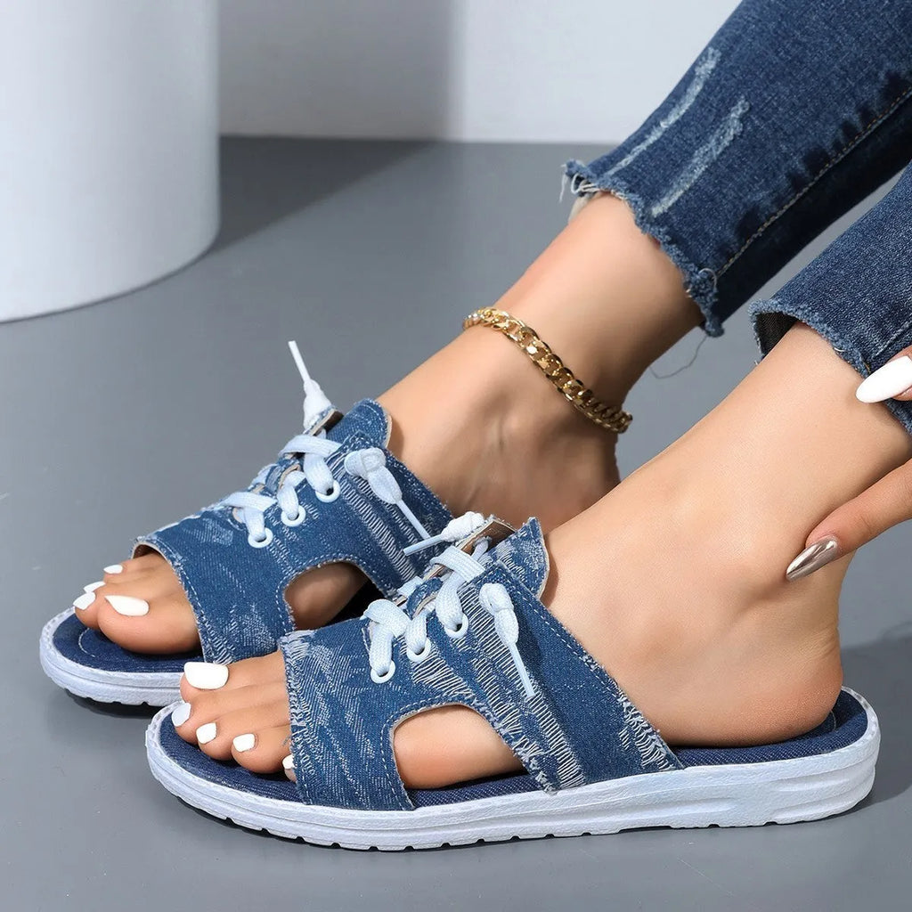Blue Roman style women's flat canvas slippers with cloth lining, shown from the side.