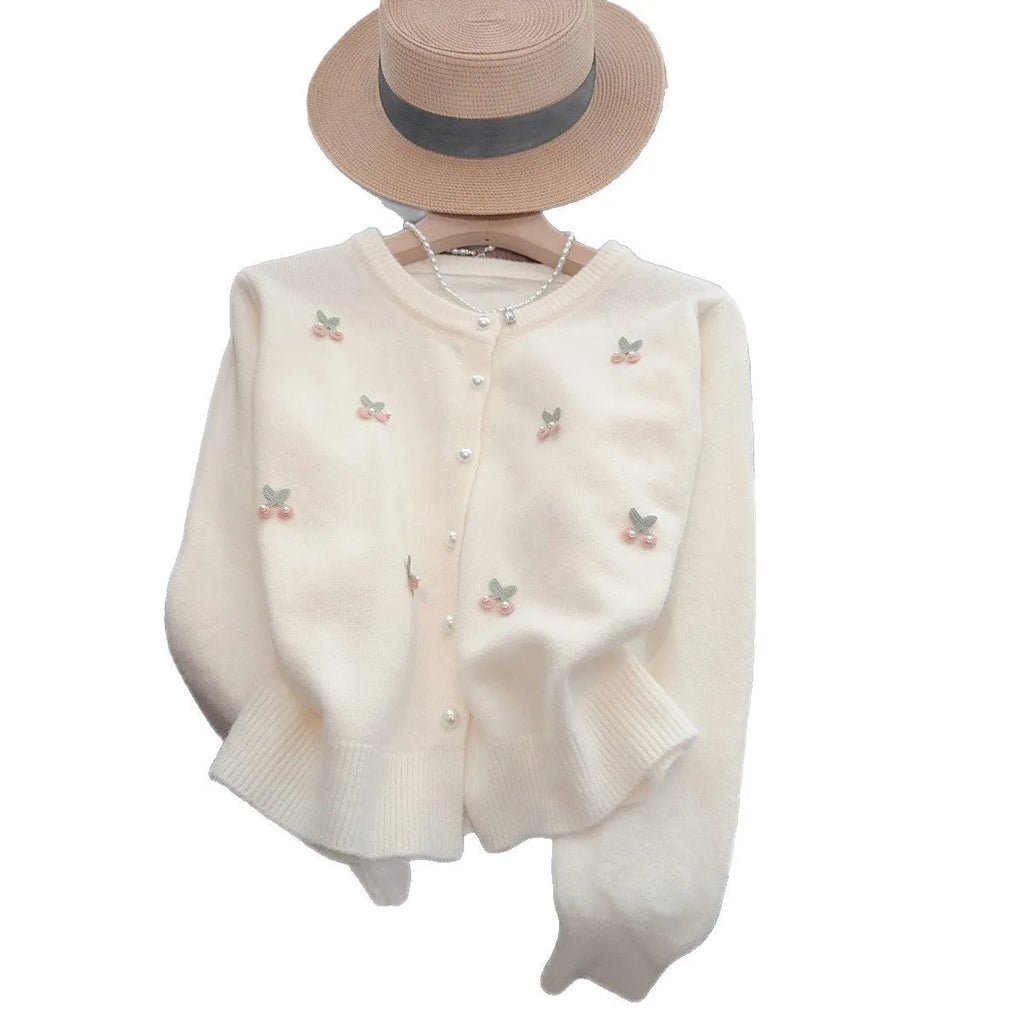 Women's slim fit cashmere cardigan with bead details on hanger, showing gentle round neckline in pink colour.