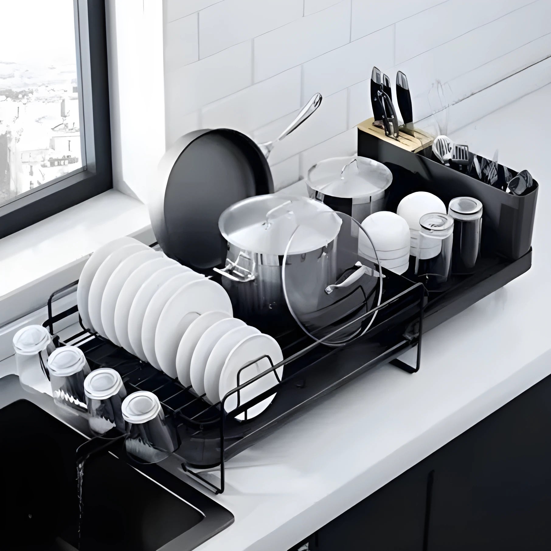 A retractable, foldable carbon steel kitchen drain rack holding cutlery and cups.