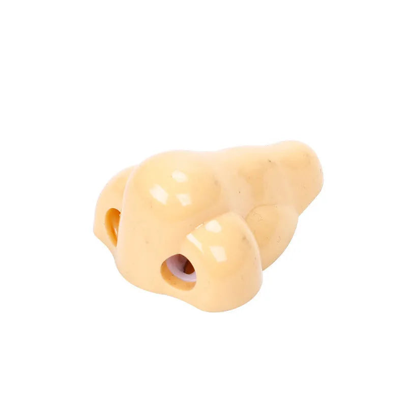 Flesh colour geometry plastic pencil sharpener with big nostril hole measuring 58x45x30mm