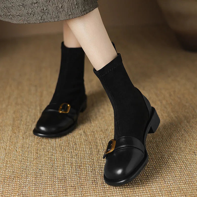 Women's black low heel Martin boots with round toe, belt buckle stitching, and lace-up front.