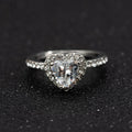 Women's fashion crystal heart-shaped ring in rose gold or silvery on a white background.