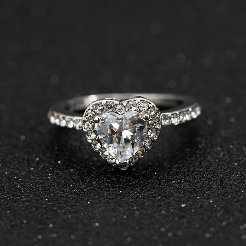 Women's fashion crystal heart-shaped ring in rose gold or silvery on a white background.