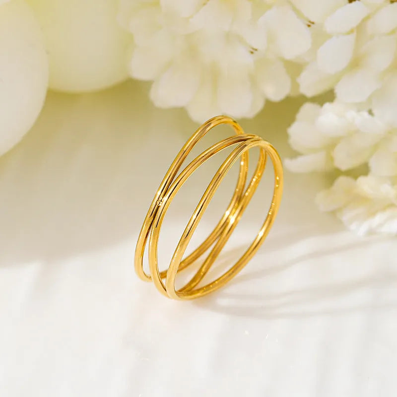 Gold colour titanium steel women's ring with three-layer geometric line design in coiled construction