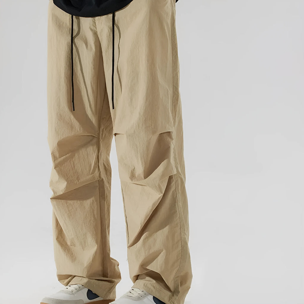 Men's thin ice silk nylon trousers in a loose straight leg fit, shown in apricot colour