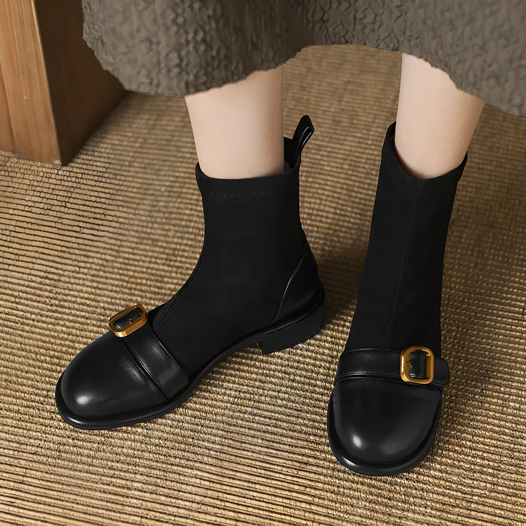 Women's black low heel Martin boots with round toe, belt buckle stitching, and lace-up front.