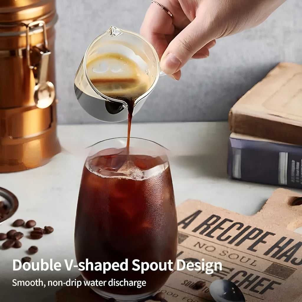 Two white modern double mouth transparent glass coffee cups on a table.