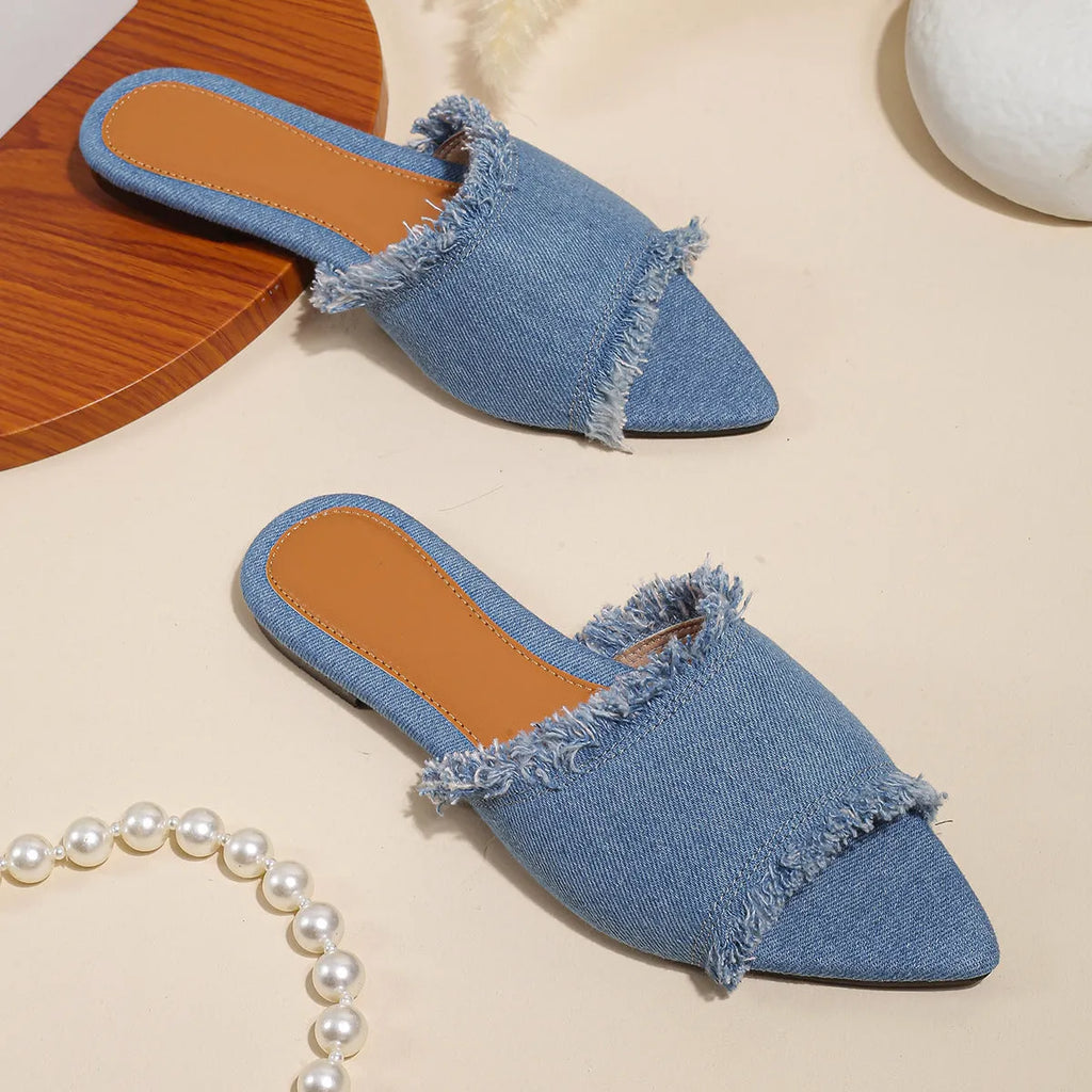 Women's flat denim slippers with a tassel detail, shown in apricot colour.