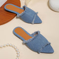 Women's flat denim slippers with a tassel detail, shown in apricot colour.