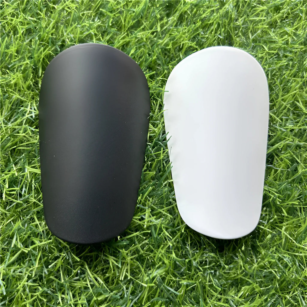 Extra small plastic football shin guards measuring 8cm by 5cm with elastic straps