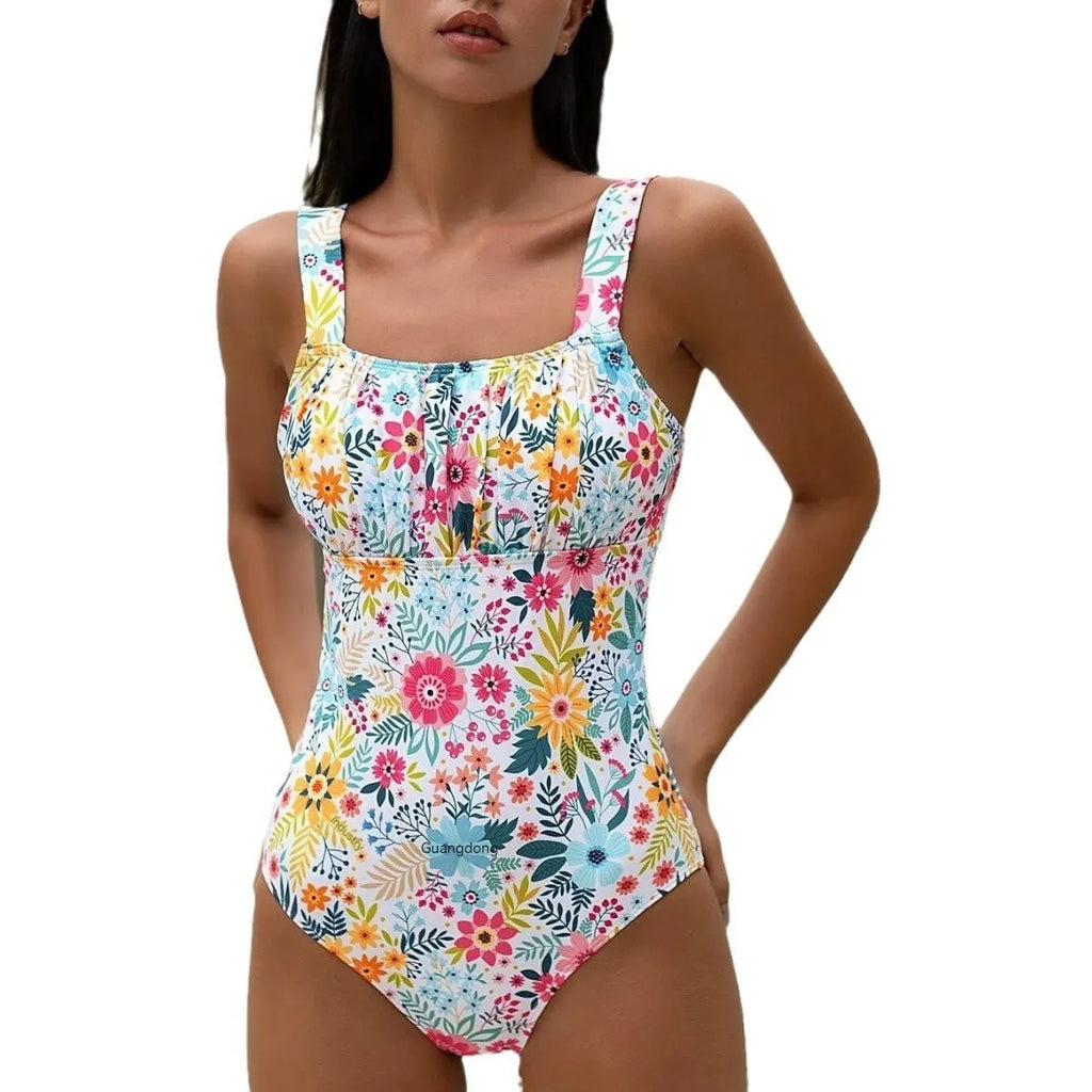 Women's floral print one-piece swimsuit showing full coverage design and pastoral pattern