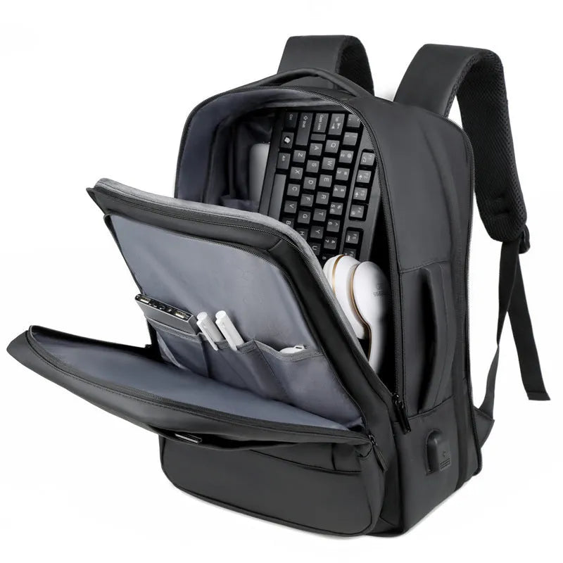 Large black waterproof Oxford cloth backpack with curved shoulder straps on a grey background.