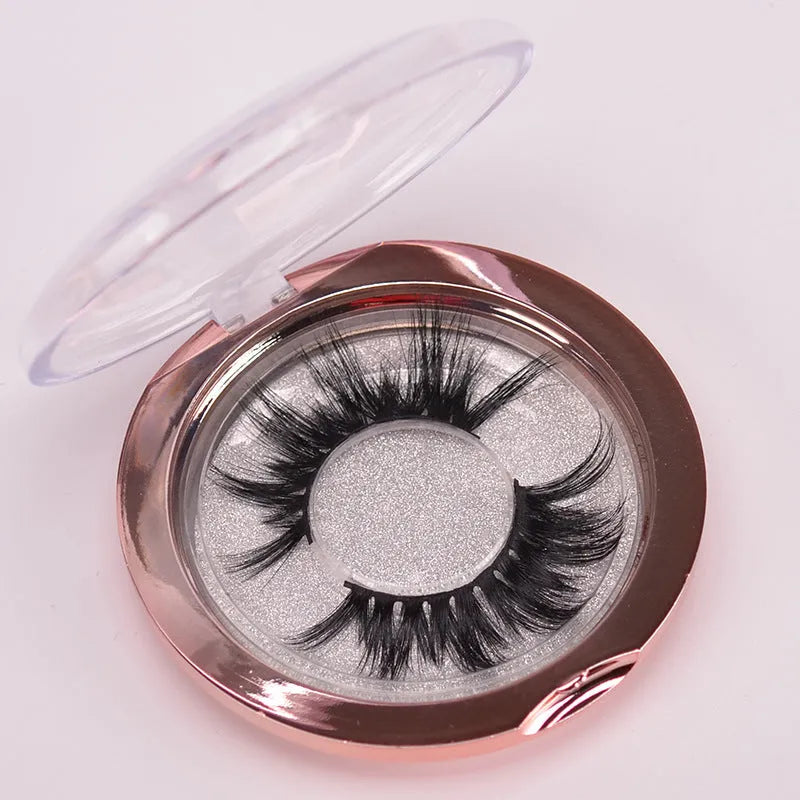 5D Mink False Eyelashes set with hair cap and double-headed brush on a pink background.