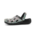 Black women's platform sandals with a perforated design and rhinestone details on the EVA upper.