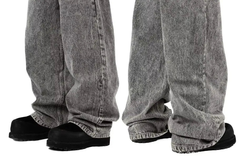 Grey loose straight-leg cotton denim trousers for men and women showing mid-waist design