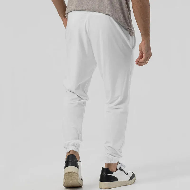 Men's casual track sweatpants in straight-leg tapered design with cotton blend fabric
