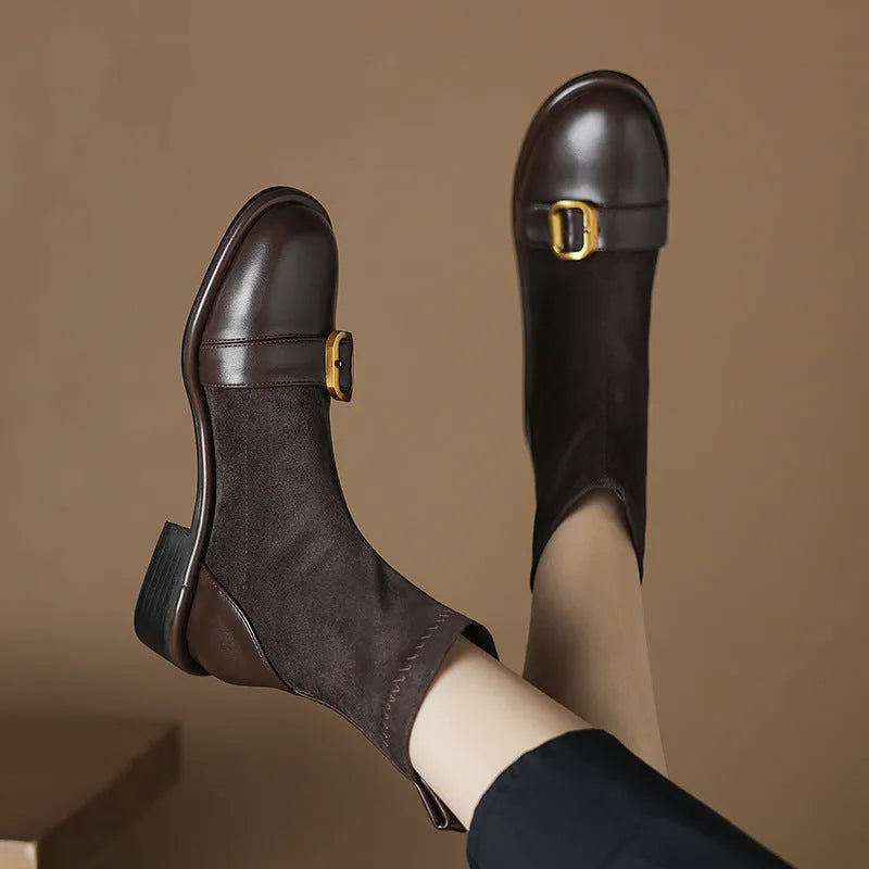 Women's black low heel Martin boots with round toe, belt buckle stitching, and lace-up front.
