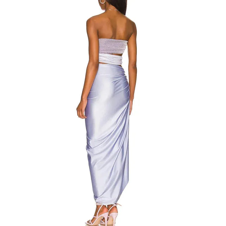 Purple women's one-piece swimsuit with matching wrap skirt on beach