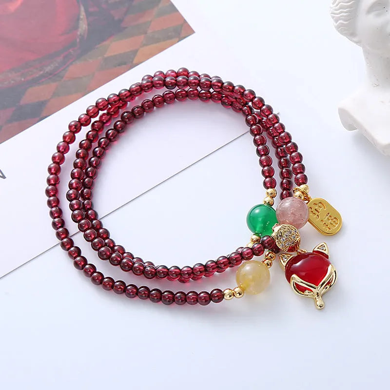 Natural garnet fox bracelet with adjustable rope closure in purplish red colour