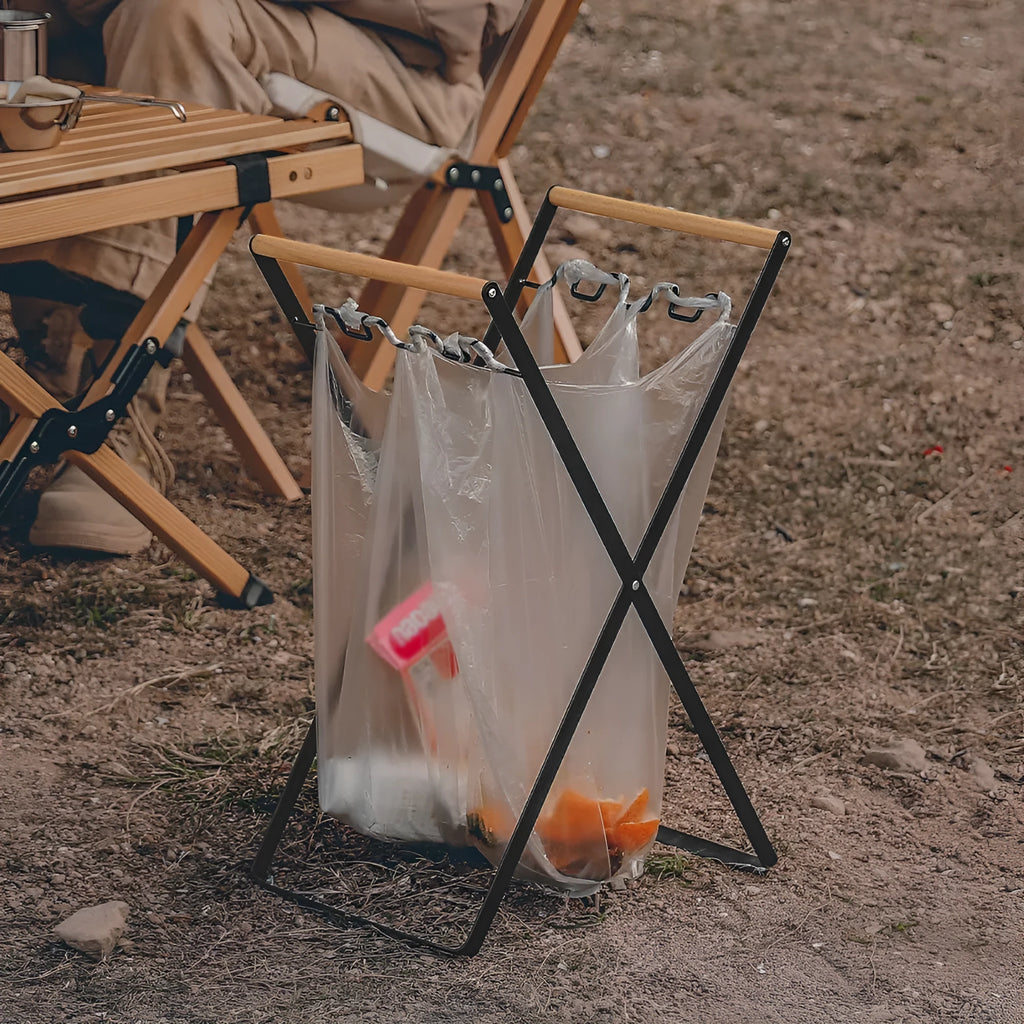 Iron and wooden folding trash storage rack for outdoor rubbish bags.