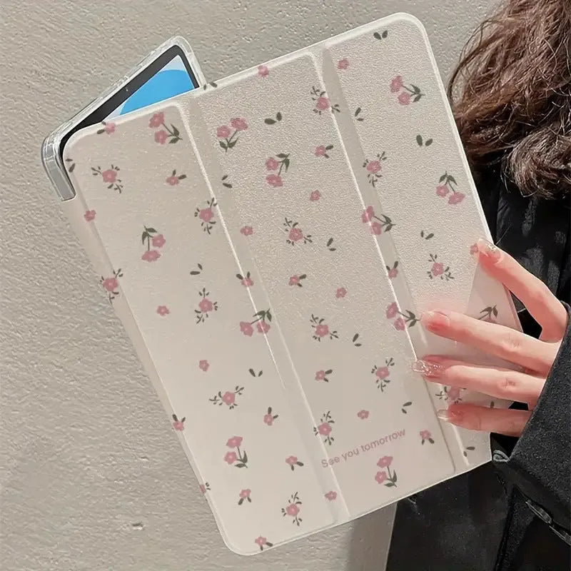 Transparent floral patterned tri-fold hard case for Apple iPad showing stand angle.