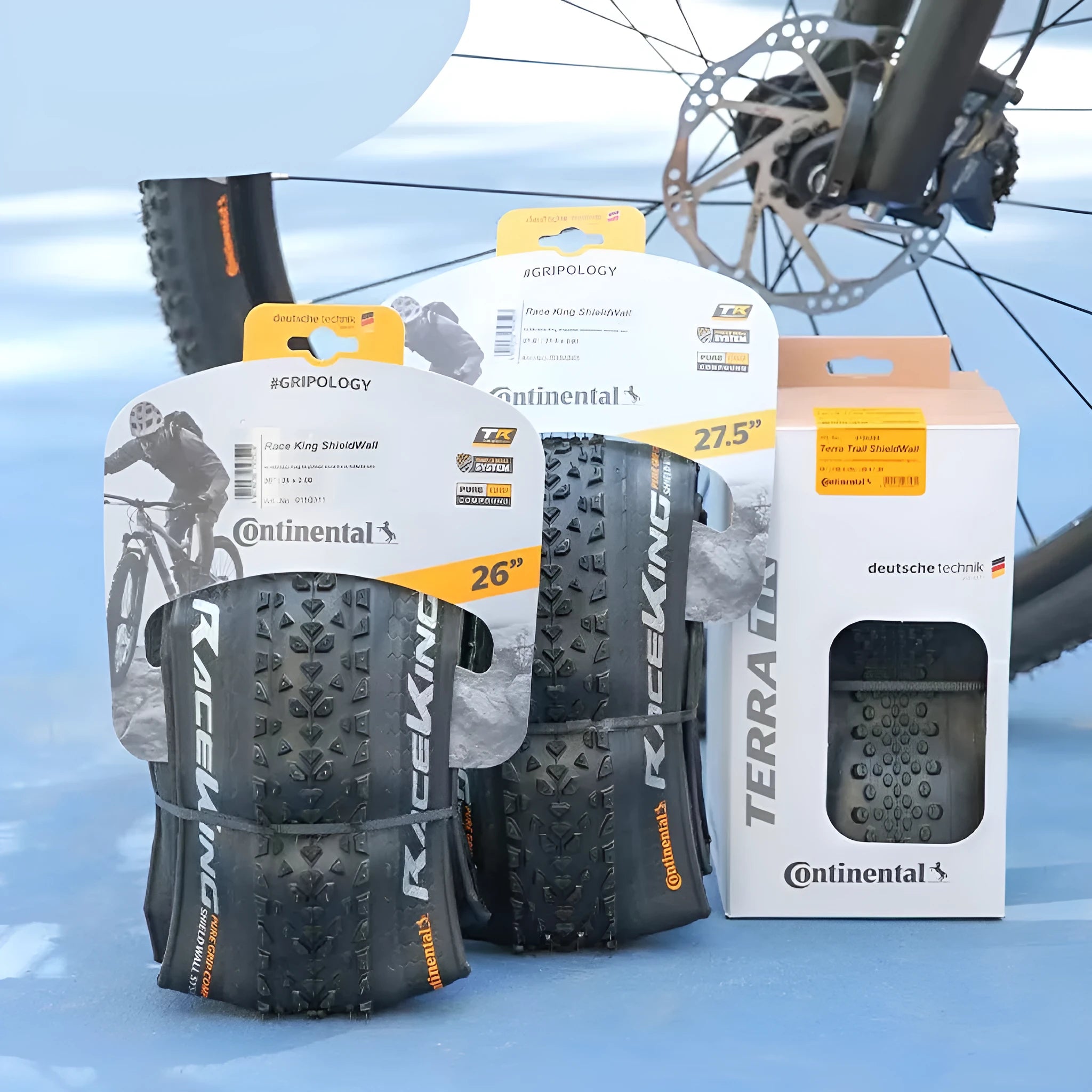 Mountain bike outer tyre showing yellow sidewall, with folding bead and tread pattern for off-road use.