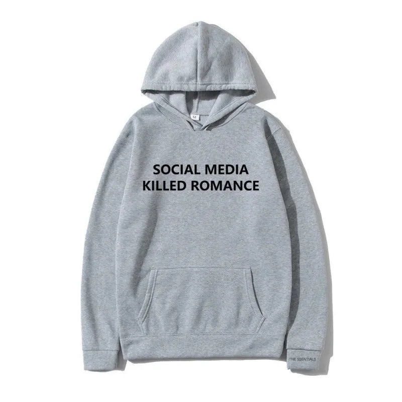 Man wearing a slim fit grey hoodie with a printed spring letter design on the front.