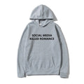 Man wearing a slim fit grey hoodie with a printed spring letter design on the front.