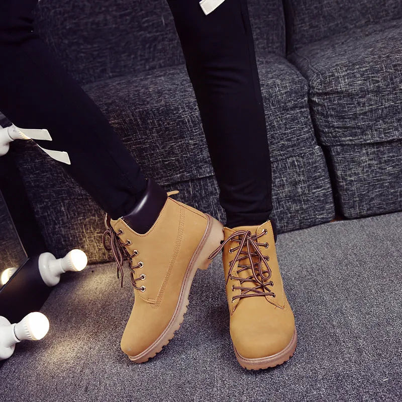 Men's pink high-top Martin boots with round toe and front lace-up on a flat bottom.