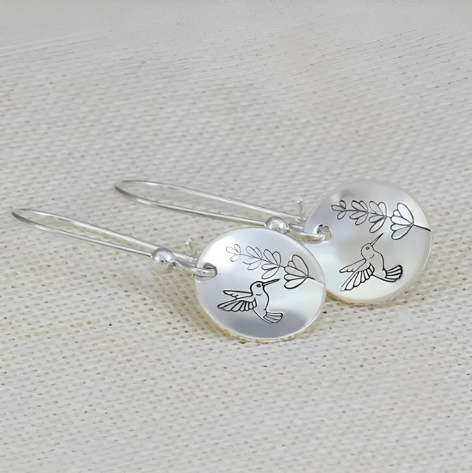 Silver colour women's earrings with bird, flower and leaf designs in round zinc alloy construction