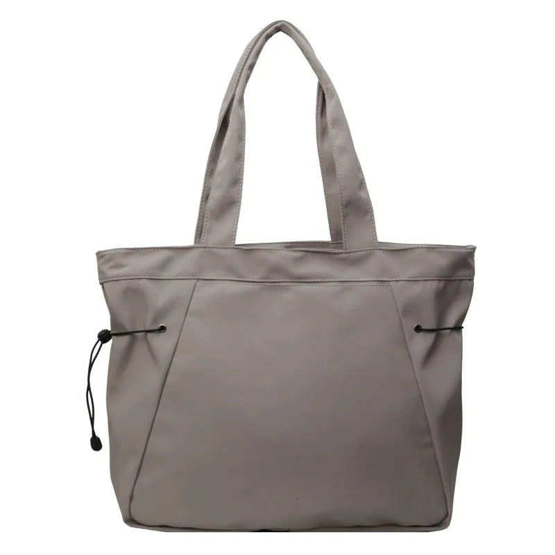 Oxford cloth shoulder tote bag in folding design showing soft construction and shoulder strap