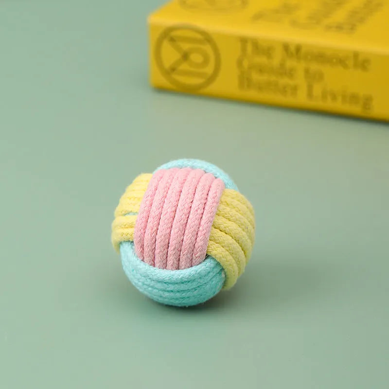 Four handmade plush cotton ball cat toys in blue powder, green blue, and pink green colours for teeth grinding play