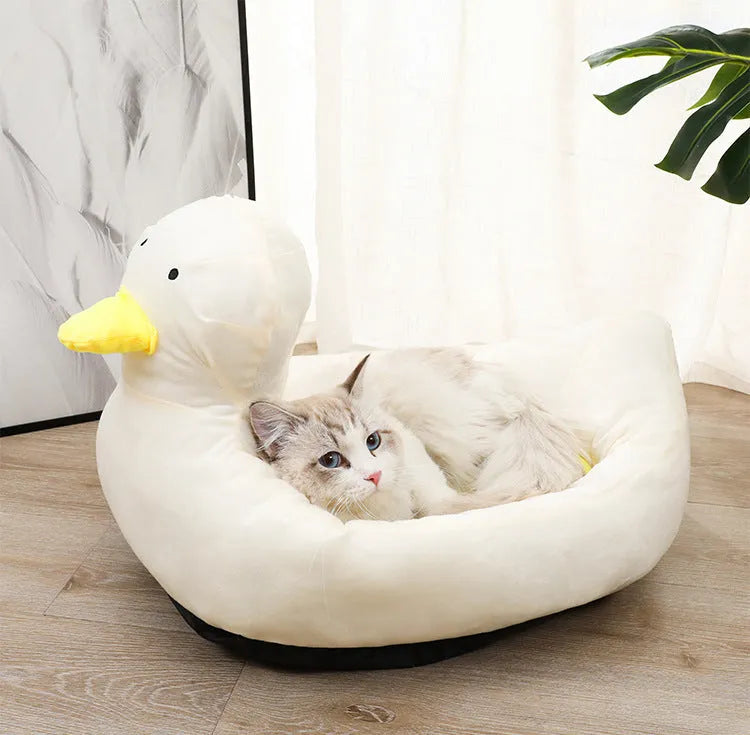 Blue duck-shaped fluffy pet bed sofa for small dogs and cats on a wooden floor.