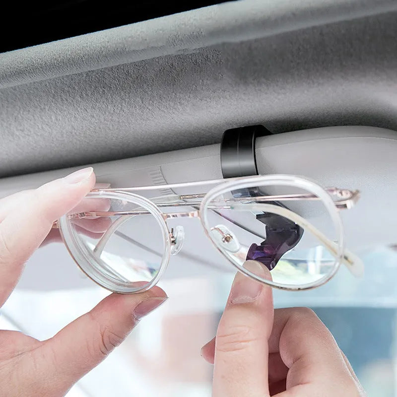 Black plastic car sunshade clip holder for glasses and tickets on a car visor